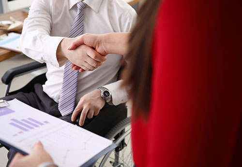 Lawyer guiding a client as they sign a legal document related to supplemental security income (SSI).